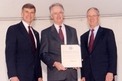 After presenting Lincoln Laboratory with the Secretary of Defense Medal for Outstanding Public Service, Ron Sega (left), director of defense research and engineering in the Department of Defense, posed with Lincoln Lab's director, David Briggs (center), and President Charles Vest.