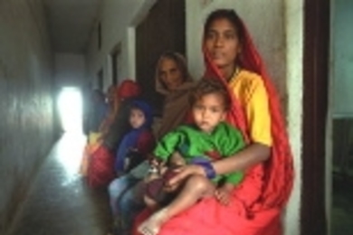 A woman and her sick child wait to be seen at the International Buddhist Society free clinic in Lumbini, the birthplace of Buddha.