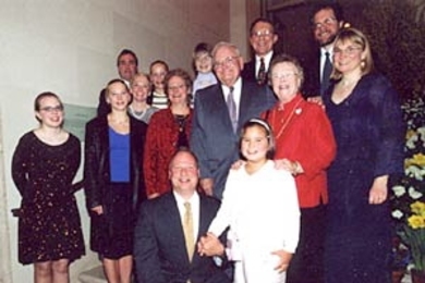 Professor Paul E. Gray and Priscilla K. Gray,  surrounded by their children and grandchildren at a ceremony renaming the President's  House to Gray House.