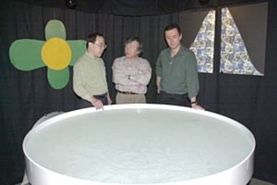 Research scientist Kazutoshi Nakazawa  (left), Professor Susumu Tonegawa (center) and Professor Matthew Wilson stand  next to the water tank where mice were tested for their memory of the location  of a submerged platform.