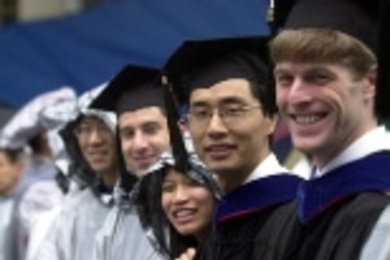 Graduates remain cheery despite the drenching they got at Commencement.