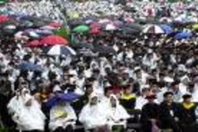 A very colorful, if very wet, crowd of families and other well-wishers sat        through a soggy Commencement.