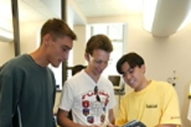 Left to right: Julien Barrier of France, MIT's Martin Jonikas of the United States and Alexandre Takeshi Ushima of Brazil collaborate on building a robot from scratch using a tablet PC as part of the International Design Contest. Although Jonikas won the 2.007 contest, he isn't allowed to reuse his design.