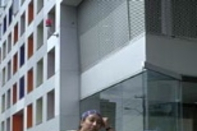 Smitha Raghunatha, a sophomore in mechanical engineering, sits atop a mountain of a friend's belongings prior to moving into Simmons.