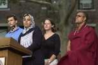 Representing their faiths at the podium are (left to right) Andrew Goldsweig, a Jewish senior in chemistry; Sarah Saleh, a Muslim graduate student in aeronautics and astronautics; Maureen Long, a graduate student in earth, atmospheric and planetary sciences, representing Christian traditions; and Buddhist Priyadarshi Shukla of the Harvard Divinity School.