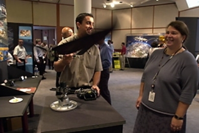 George Costa (S.B. 2000) shows fellow alumnus Jamie Anderson (S.M. 1992, Ph.D.) the ornithopter he's working on at Draper Lab at the last week's Tech Expo.
