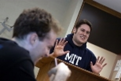 Senior Patrick Nichols (right) makes a point during a recent debate as sophomore Benjamin Hebert listens in the foreground.