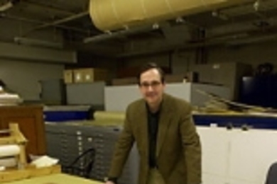 Gary Van Zante looks at part of the MIT Museum's        architecture and design collection.