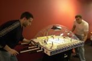 Dave Milanes (left), a graduate student in aeronautics and astronautics, and Dan Kirk, a postdoctoral associate in aero/astro, get into a game of table hockey in the new game room in the Stratton Student Center.