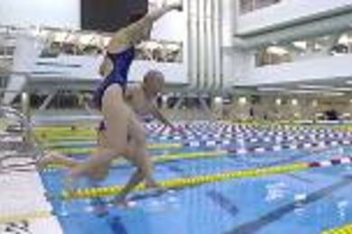 Al and Barrie Zesiger leap into the pool early on the morning of the dedication ceremonies for the Zesiger Sports and Fitness Center last September