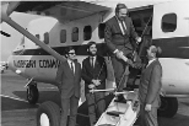 M. Curt Young (right), president of Atlantic City Airlines greets MIT Professor Eugene Larrabee. The gentlemen at left were not identified.