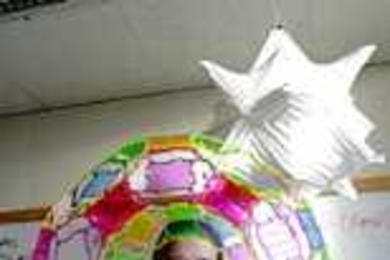 Erik Demaine, an assistant professor of EECS, shows off some of his origami and other creations.