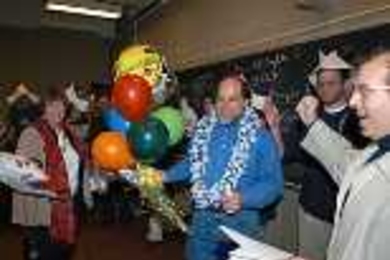 Professor Ronald L. Rivest enjoys the revelry at a surprise party in his 6.045 class to celebrate his selection for the Turing Award. Among the celebrants were Be Blackburn (left), Rivest's administrative assistant for 17 years, and his colleague, Professor Silvio Micali (far right).