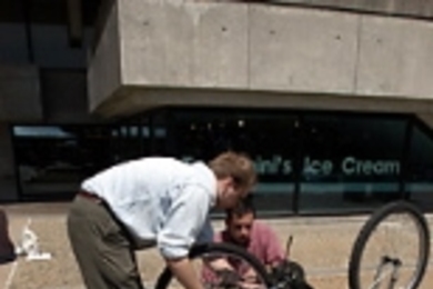 Electrical engineering and computer science graduate student Wojciech Giziewicz (standing) lends a hand to Chris Guerra, a graduate student in aeronautics and astronautics, during an Earth Day bike maintenance session last Friday.
