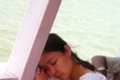 M.B.A. student Jacqui Tan snoozes during the return-trip boat ride from the Elephant Caves in Mumbai, India.