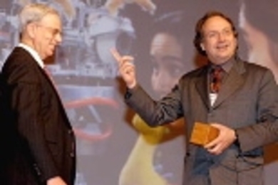John V. Guttag, left, head of the Department of Electrical Engineering and Computer Science, plays "Robot John" for AI Lab director Rodney Brooks to illustrate how a robot learns tasks.