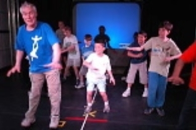 Former New York City Ballet principal dancer Jacques d'Amboise leads children through RoBallet moves.