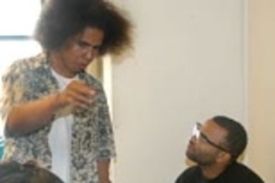 MITE2S students Noah Hood (standing) and Amanda McCoy confer with design instructor Marc Graham before the robotic competition.