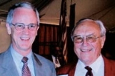 Alf Bjercke (MIT 1943), right, presents his thesis to MIT President Charles M. Vest, which he plans to defend this winter to three professors at the University of Oslo.