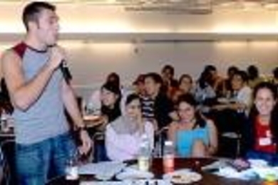 International students gathered to get to know each other, and to share how some of their expectations of the United States matched up with their own experiences. As freshmen mingled with upperclassmen mentors, many laughs ensued, but never so many as when Anton Katz, a freshman from Israel, presented his experiences in the form of a stand-up comedy routine. Next to him is mentor Saba Gul of Pakis...