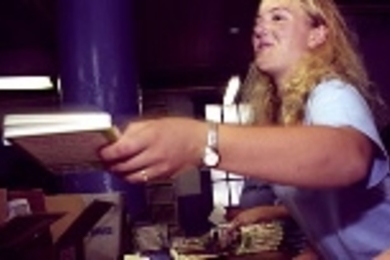 Freshman Holly Owens assembles braille pages for a Dr. Suess book at the National Braille Press during CityDays.