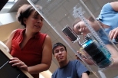 Professor Anette "Peko" Hosoi (left), graduate student Brian Chan and junior Catherine Koveal demonstrate RoboSnails I and II. RoboSnail I has since been rebuilt to be the same size as the smaller RoboSnail II.