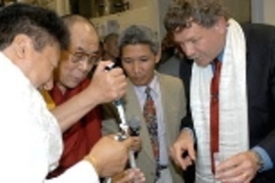 The Dalai Lama was given a tour of the Whitehead Institute/MIT Center for Genome Research by biology professor Eric Lander (right), head of the Genome Center and the Broad Institute. Yama Chompel (left) a Tibetan, instructs the Dalai Lama in pipetting isopropel into mouse DNA in the lab. Next to the Dalai Lama is his translator, Thupton Jinpa.