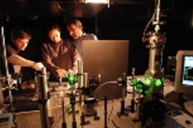 Postdoctoral associate Preston Snee, graduate student Aetna Wun and Professor Daniel G. Nocera (left to right) use a laser microsensor.