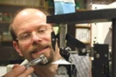 Professor Michael Yaffe loads a tiny protein crystal onto an X-ray diffractometer machine in order to study its structure.