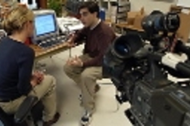 Keith Winstein, co-creator of the Library Access to Music project, demonstrates LAMP to reporter Melissa Sherman of WHDH-TV on Monday.