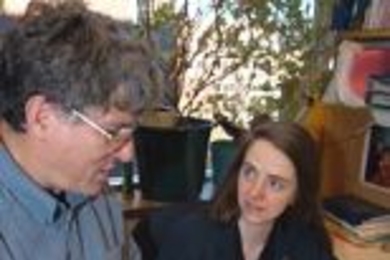 Professor David E. Housman of biology, left, and Amanda Shearman, research scientist in the Center for Cancer Research, discuss some of the images they use in their work with gene variation and cardiovascular disease.