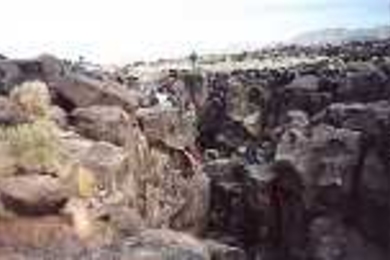 The class does some climbing at California's Fossil Falls, the remains of a waterfall carved by the Owens River thousands of years ago. Students found obsidian chips and places in the rock where women once ground grain at a Native American settlement on the river bank.