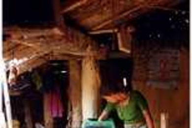 A woman in Nepal cleans water for her family using a filter developed by MIT researchers.