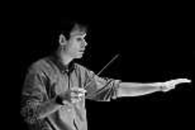 Fred Harris dons his conducting hat during an MIT Wind Ensemble rehearsal.