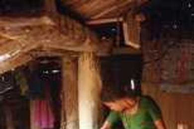 A woman in Nepal cleans water for her family using a filter developed by MIT researchers.