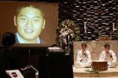Members of Oori, MIT's Korean drum group, perform at the memorial service for Daniel Mun, as images of the 20-year-old student are projected onto a screen.