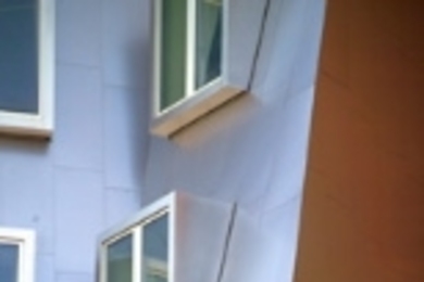A construction worker puts finishing touches on the nearly completed Stata Center.