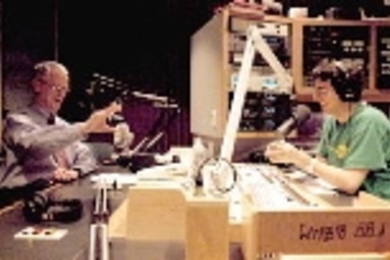 President Charles M. Vest chats with WMBR radio host Eric Chemi during a recent taping of "Dinnertime Sampler," where guests play CDs and talk about their favorite pieces of music. The show featuring Vest will air tonight.