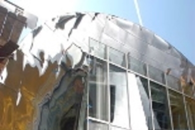 Two of the hallmark design elements of the Stata Center: a polished surface and, in its reflection, an irregularly shaped exterior wall.
