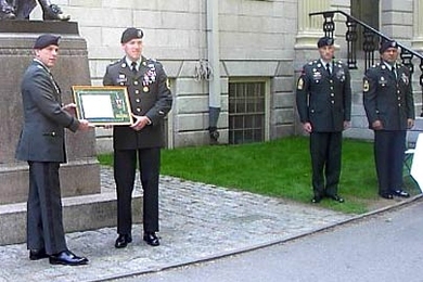 Staff Sergeant Joseph Howell, second from left, receiving his award from Col. J.C. Allard, the First Brigade Commander, at Harvard University prior to June 9th Commissioning Ceremony.