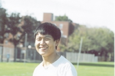Tian He, who writes Patriots' news in Mandarin, strikes a Tom Brady-like pose during an intramural football game on Briggs Field.