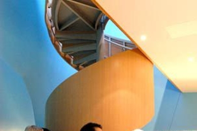 Recent revelers at the new R and D pub at the MIT Stata Center were, from left, Professor John Guttag; architect Thomas Kim (behind Guttag); Simon J. Hernandez, research technician for W3C; Professor Alan Willsky, and Karen Gardner, personnel coordinator for CSAIL. Guttag and Willsky, both professors in EECS, created the pub's wine list.