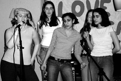 Left to right: Sophomores Katelyn Giovannuci, Adrienne Hunacek, Jayodita Sanghvi, Emily Pfeiffer and Roshni Cooper belt out a song like rock stars during last Friday's Coffeehouse karaoke night sponsored by SaveTFP.