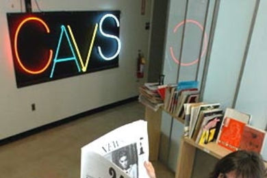 Larissa Harris, associate director of the Center for Advanced Visual Studies, checks out 24/7, a Lithuanian art periodical that is part of the Traveling Magazine Table exhibition hosted by the center.