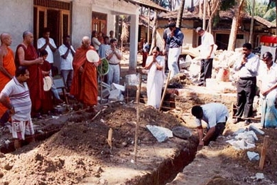 Buddhist monks pray as construction begins of single family houses for tsunami victims.