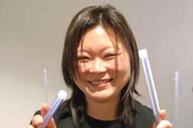 Assistant Professor J. Meejin Yoon of architecture shows off some of the light rods that will be in her exhibit, 'White Noise/White Light,' which opens on Kresge Oval Monday.