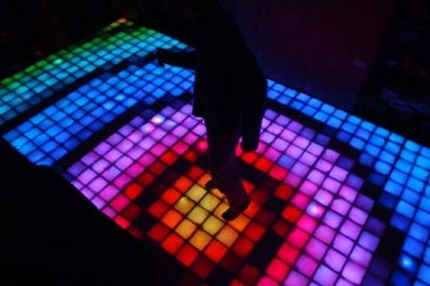 A dancer tests his disco moves on the new East Campus lounge floor.