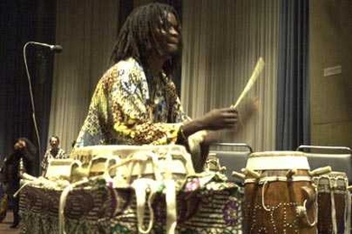 MIT resident artist and master Senegalese drummer Lamine TourÌ© will help lead 11 members of the musical group Rambax on a study tour of Senegal starting May 23. He is shown playing with Rambax, which performs Senegalese music.