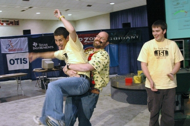 Mark Cote, winner of this year's 2.007 robot competition, gets a congratulatory hug from Professor Alexander Slocum.