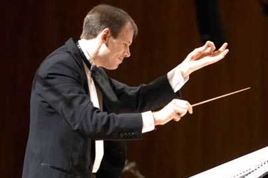 Fred Harris conducts the MIT Wind Ensemble. MIT President Susan Hockfield will perform with the ensemble on Oct. 14.